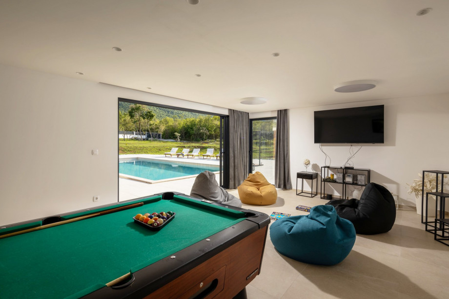There is a Playroom with a Billiard (A Pool table), a flat-screen TV, lazy bags, JGB speakers, A/C, and a direct approach to the pool area