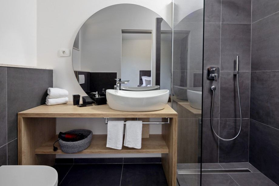 An en-suite bathroom with a shower, a sink, and a toilet