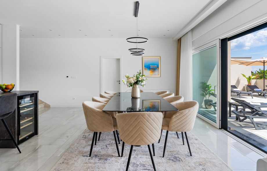 Meticulously decorated spacious dining room with a table for ten people