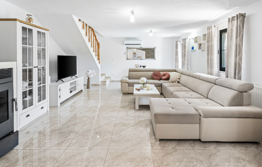 The ground floor offers a spacious living and dining area