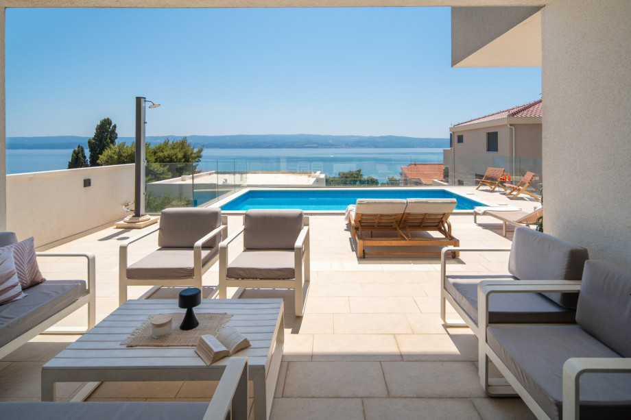 Covered lounge seating area with open sea view