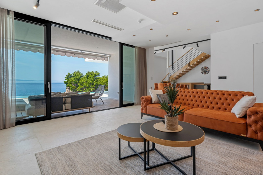 Very comfortable living room (32sqm) with sofas, flat screen TV, PS5, Bluetooth speaker system, all fully air-conditioned.