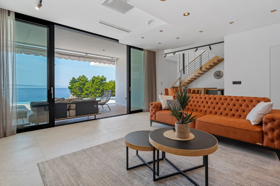 Very comfortable living room (32sqm) with sofas, flat screen TV, PS5, Bluetooth speaker system, all fully air-conditioned.