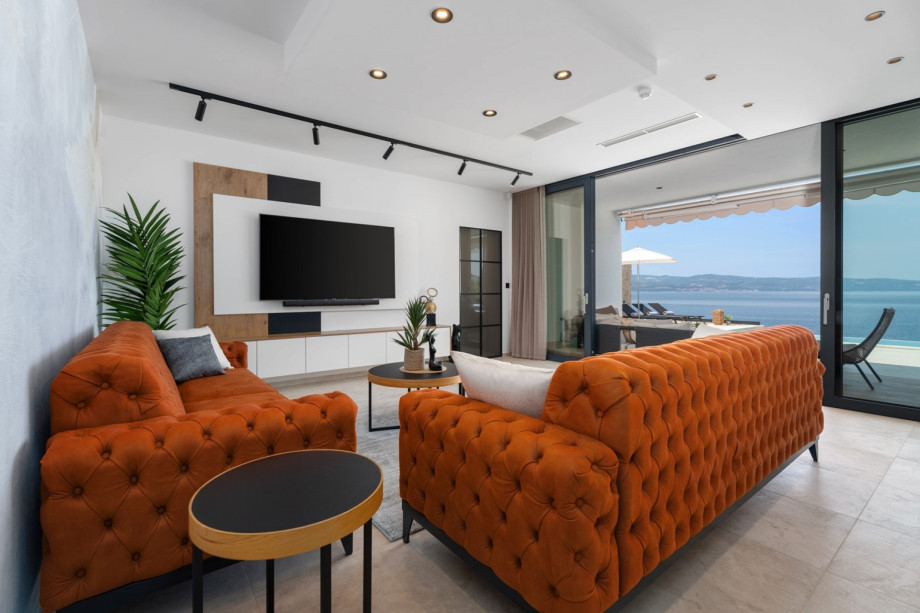 Large glass walls connecting the villa’s ground floor interior with the exterior