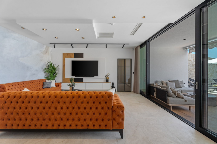 Very comfortable living room (32sqm) with sofas, flat screen TV, PS5, Bluetooth speaker system, all fully air-conditioned.