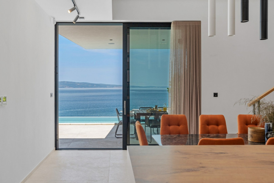 Large glass walls connecting the villa’s ground floor interior with the exterior