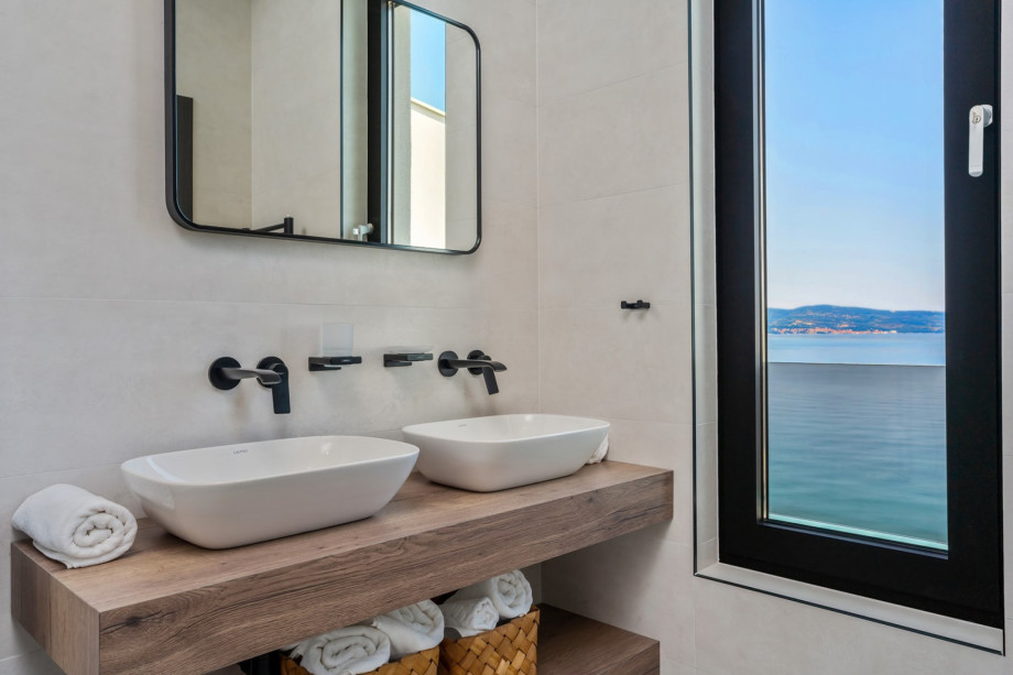 en-suite bathroom with a shower and a sea view.