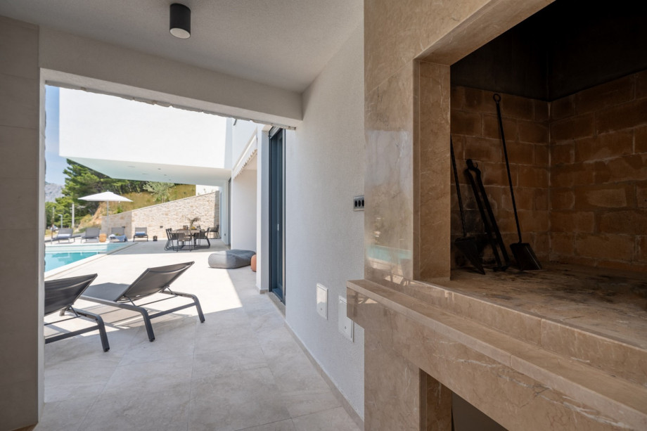 Covered outdoor dining area with a traditional barbecue for maximum relaxation and enjoying the Mediterranean climate