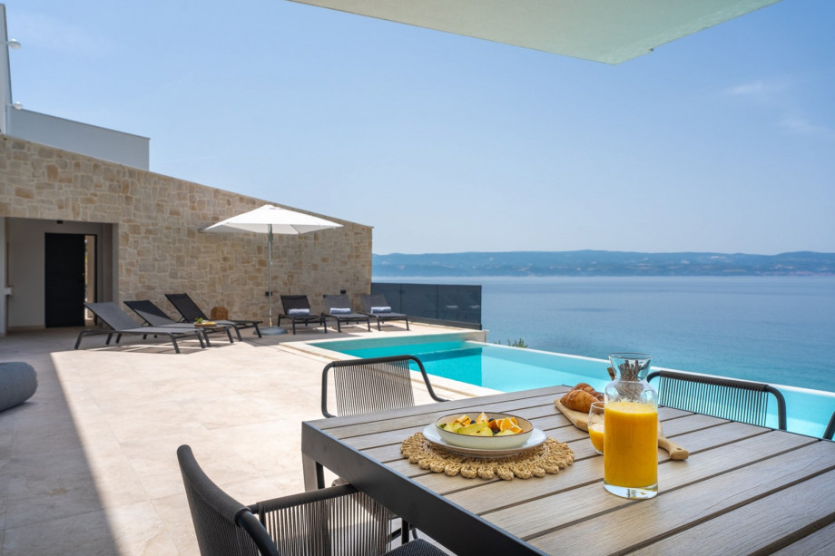 he sunbathing area with 10 deck chairs, outdoor shower