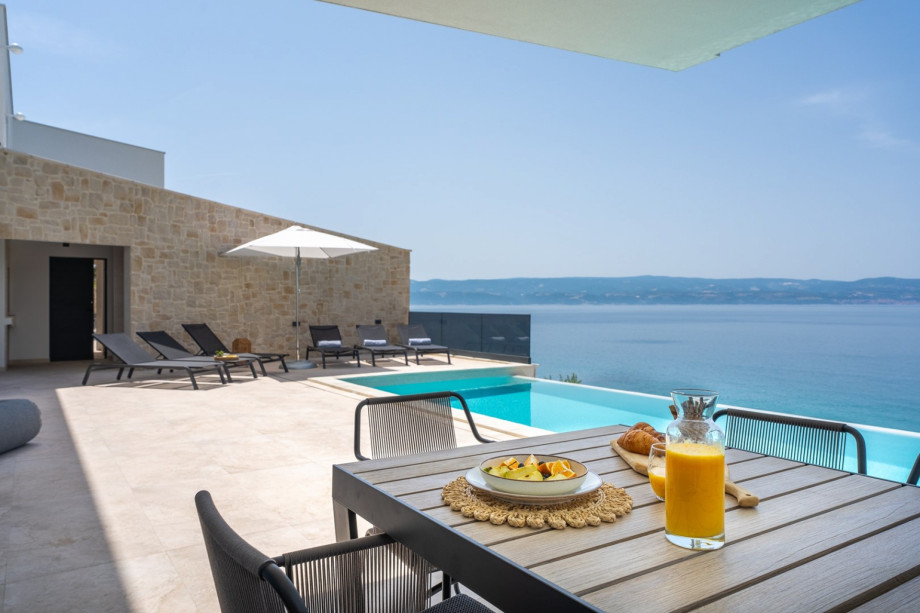 he sunbathing area with 10 deck chairs, outdoor shower