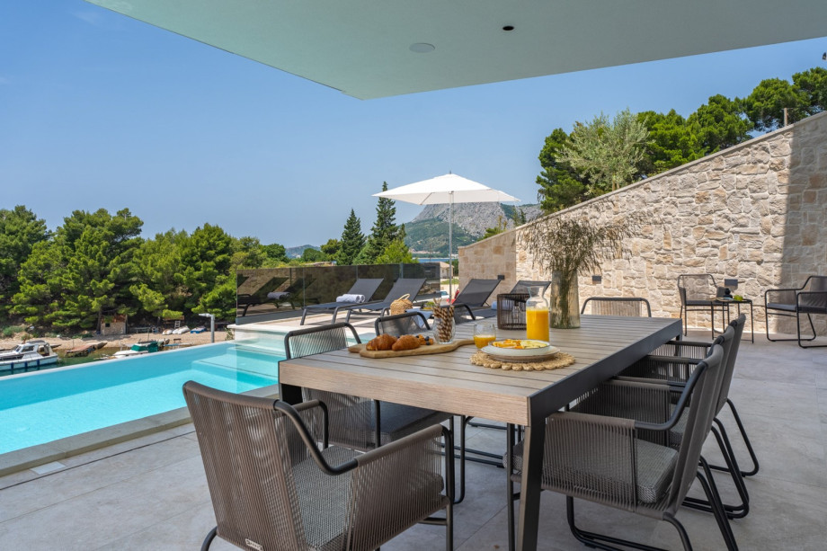Covered outdoor dining area with a traditional barbecue for maximum relaxation and enjoying the Mediterranean climate