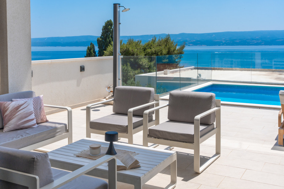 Sundeck area with 8 lounge chairs, and a covered lounge seating area