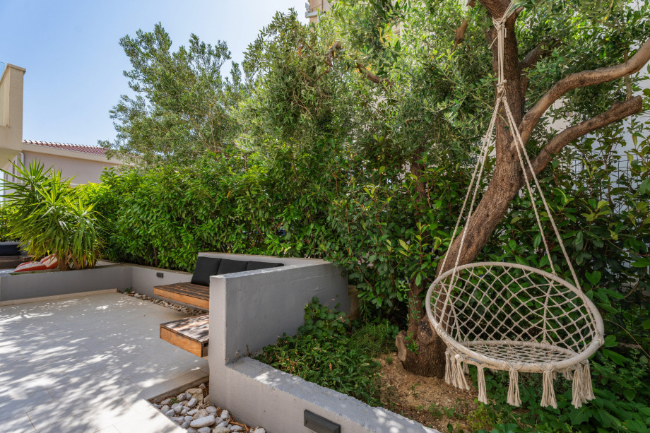 The terrace is partially covered and has a natural shade from carefully selected Mediterranean plants around the lounge