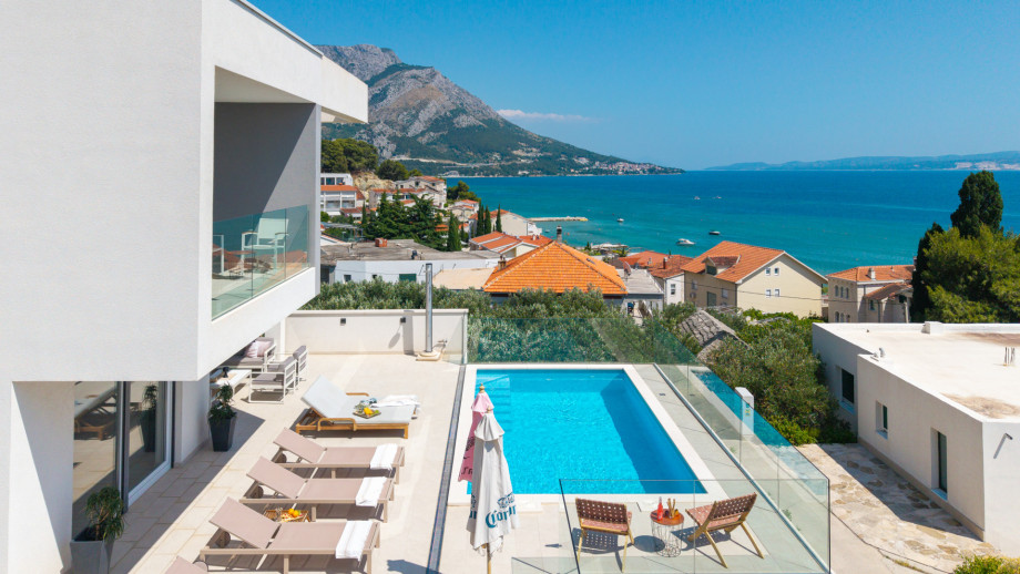 Behind the house is a secured parking lot for 4 cars & grill