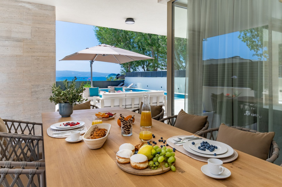 Covered terrace with a comfortable outdoor dining area for 14 people