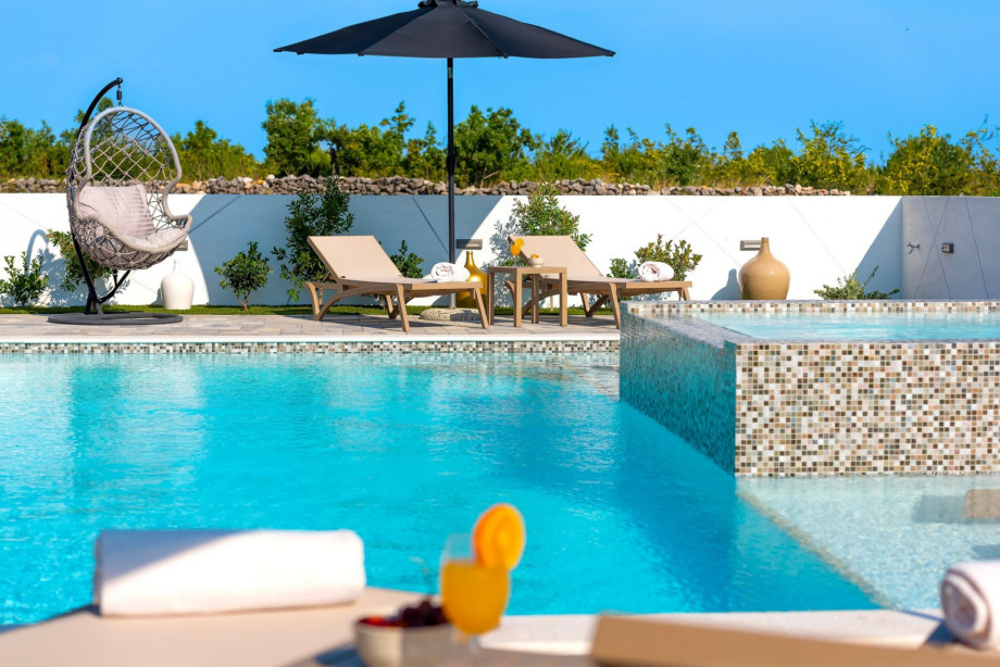 Large sun deck area with heated, 9 m x 6.5 m private swimming pool