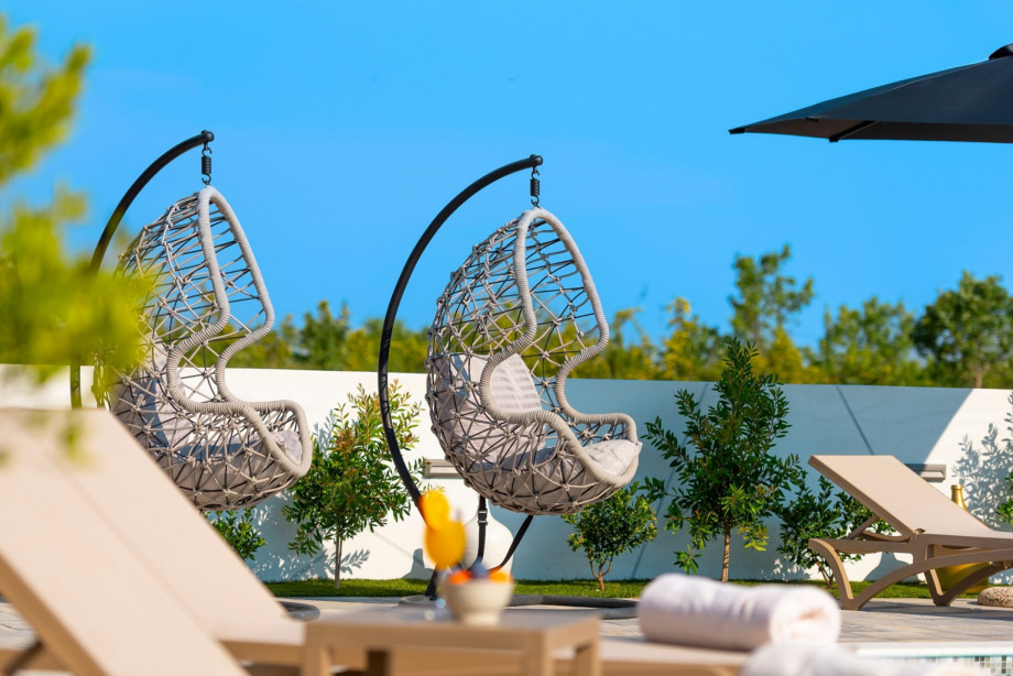 Few hanging egg chairs are available in the large, gated sun deck area