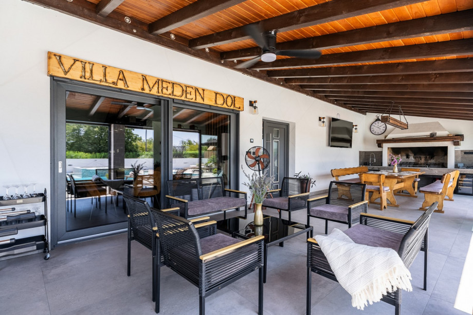 Covered dining area with wooden BBQ