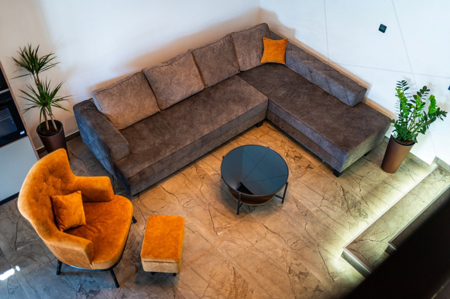 Living room with a very cozy sofa and a flat-screen TV with IPTV channels