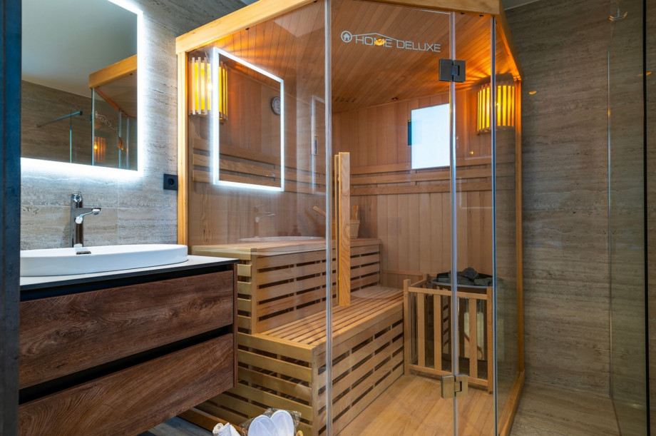 En suite bathroom with a Finnish sauna and a shower