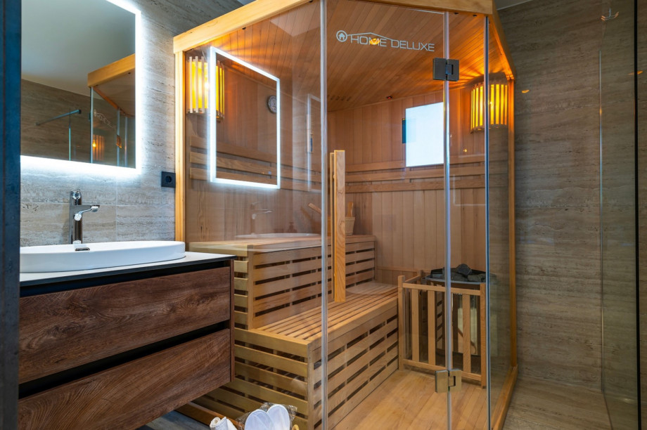 En suite bathroom with a Finnish sauna and a shower
