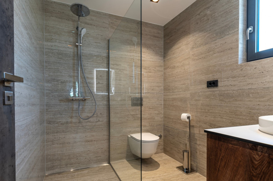 En suite bathroom with a shower, towels are provided