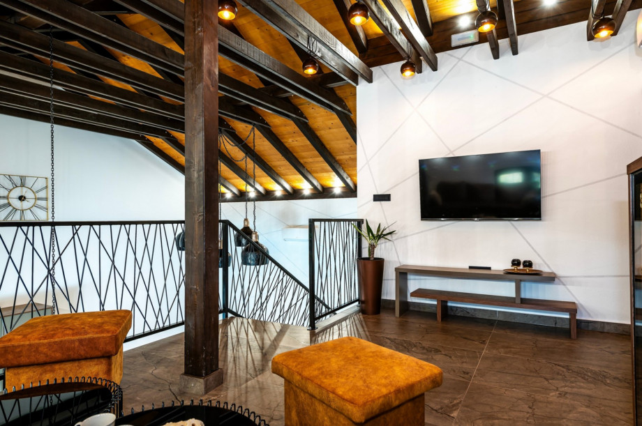 Gallery with flat screen TV with IPTV channels, a wine cooler, and air conditioning