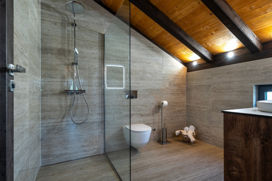 En suite bathroom with a shower, towels are provided