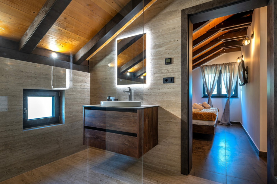 En suite bathroom with a shower, towels are provided