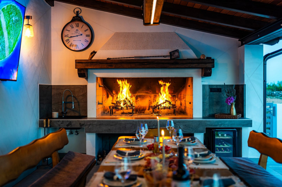 Outdoor dining area with extra refrigerator, a sink, and a cozy lounge corner that is easily accessible from the kitchen