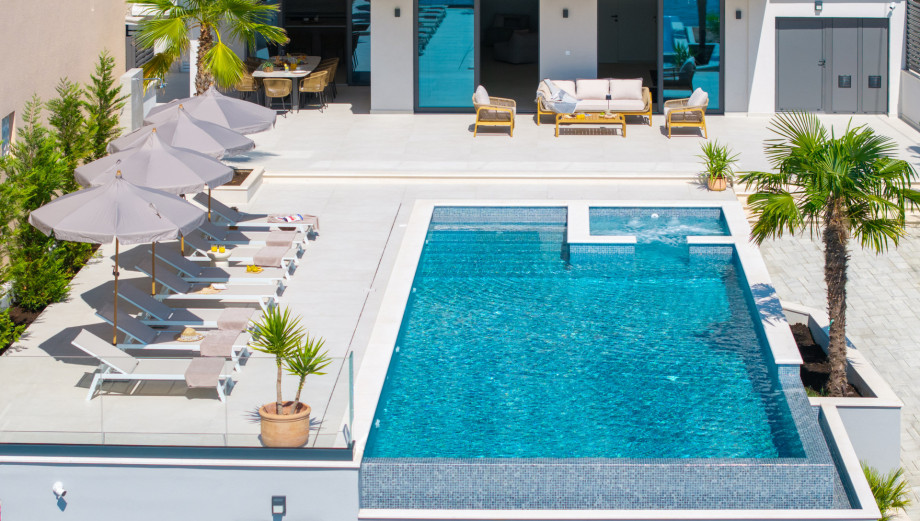 Expansive sun deck with 8 comfortable deck chairs, outdoor shower, and vibrant parasols for those sunny days