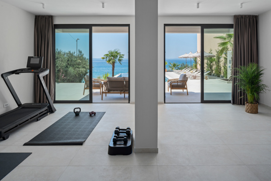 44 sqm gym with modern equipment including a treadmill, multifunctional machine, weights, and pilates gear alongside