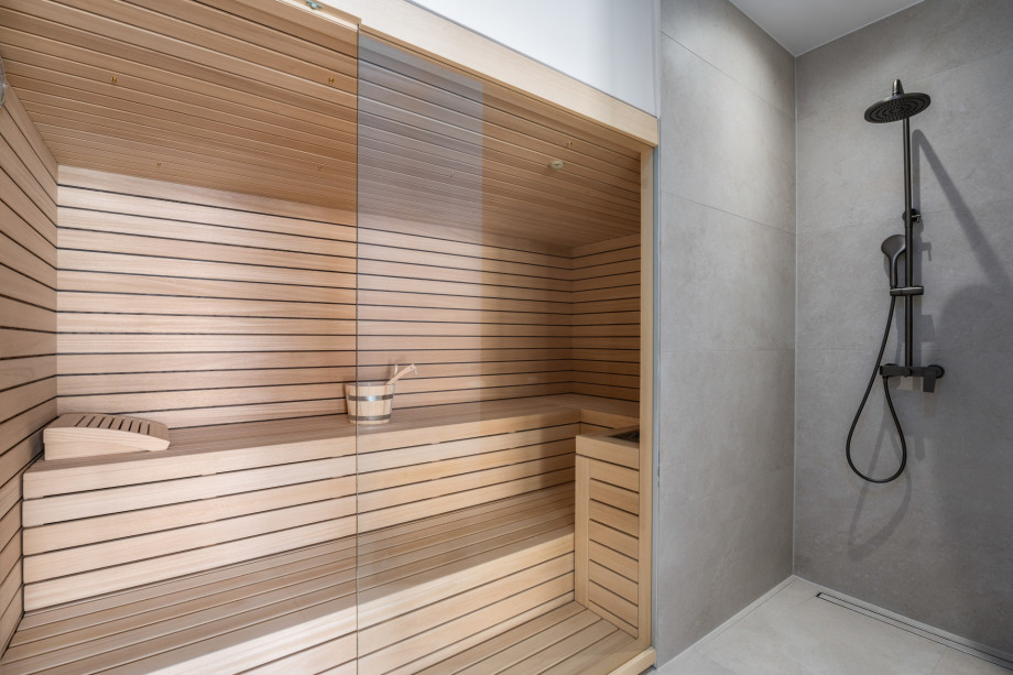 A luxurious Finnish  sauna area 12sqm with a walk-in shower for ultimate relaxation