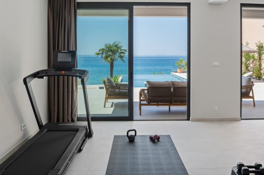 You can work out in the gym with a stunning view of the pool and the sea.