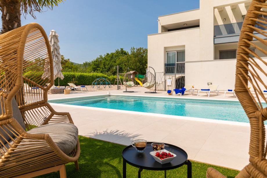 a private and heated, 5m x 10m swimming pool with a spacious sun deck area