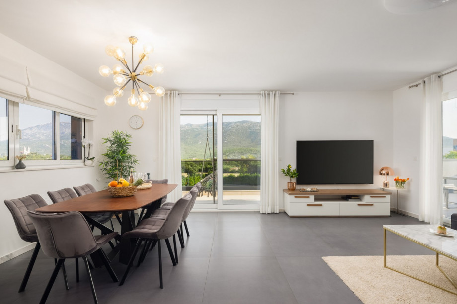 a dining and living area with terrace and lounge furniture with a pool view