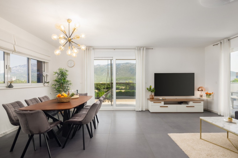 a dining and living area with terrace and lounge furniture with a pool view