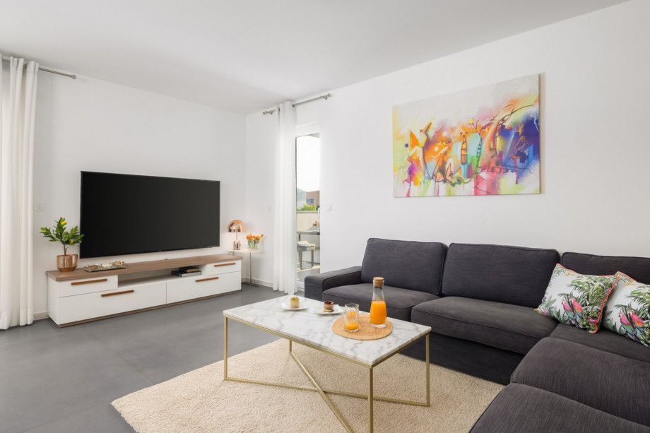 a living area with terrace and lounge furniture with a pool view