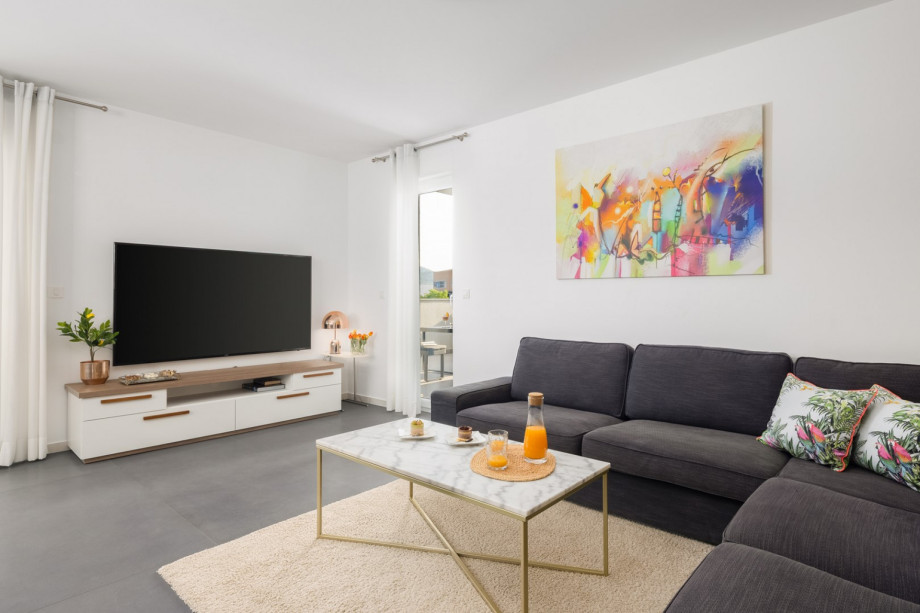 a living area with terrace and lounge furniture with a pool view