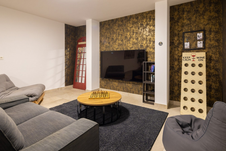 Entertainment area with pool table, darts, table football, table tennis, sofa, PS4 and TV