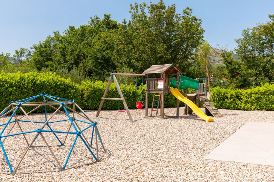 a Wooden Playhouse with a slide for your youngest