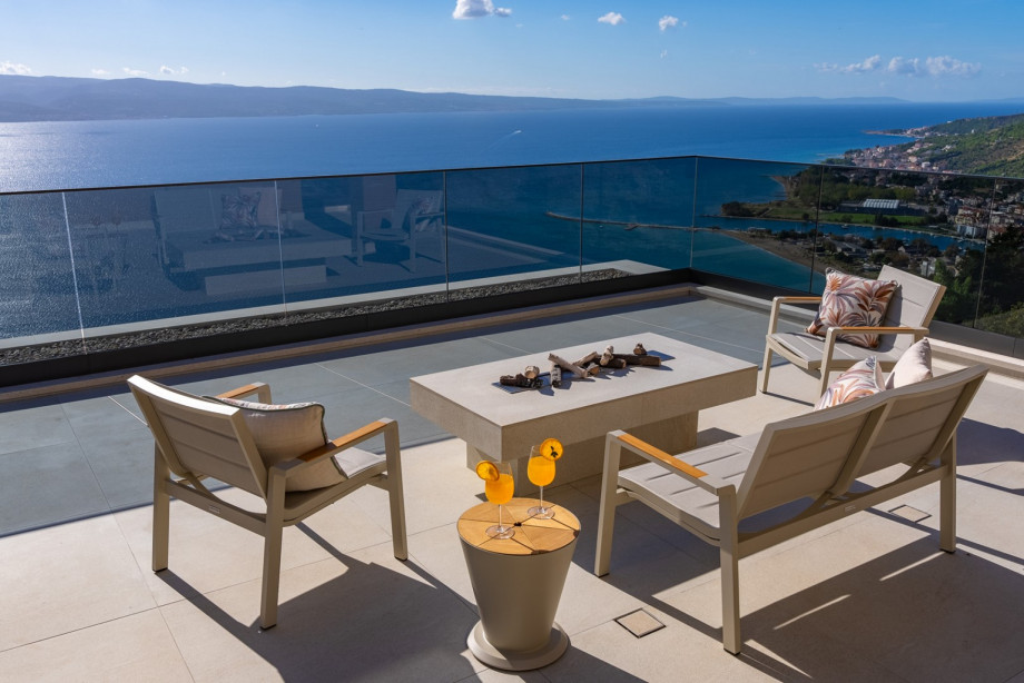 West terrace is a half-covered relaxing zone with a lounge corner and outdoor furniture for enjoying spectacular sunsets with a glass of local vine.