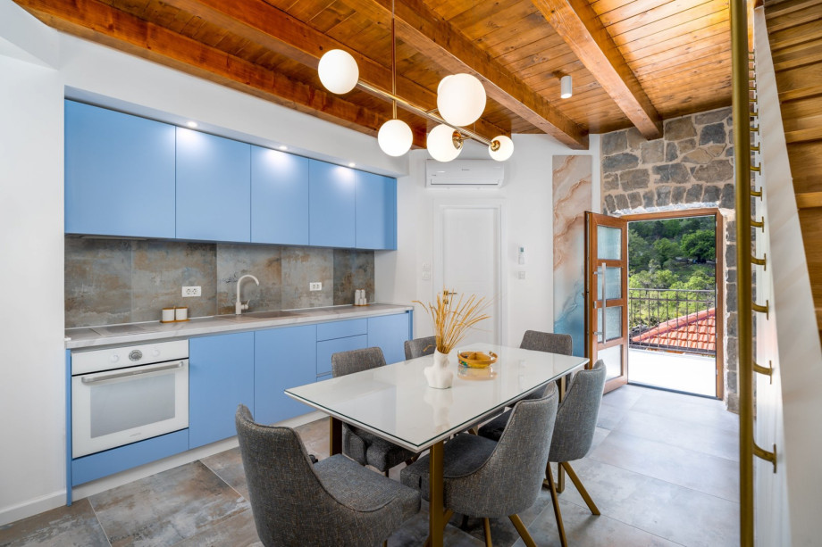 A fully equipped kitchen with a table for 6