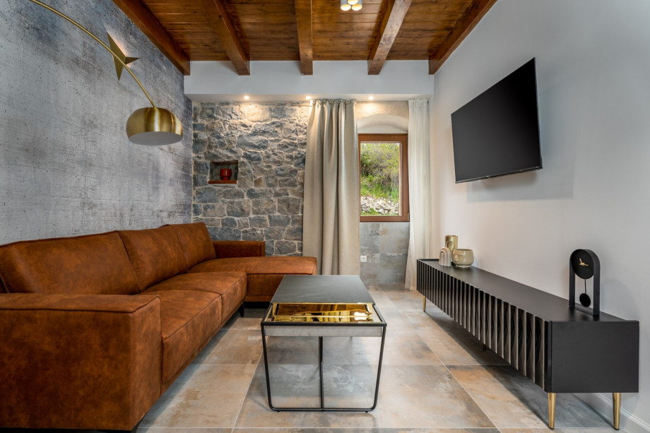 Living room with comfy sofa, flat screen TV, and WiFi, where you can spend your best vacation ever.