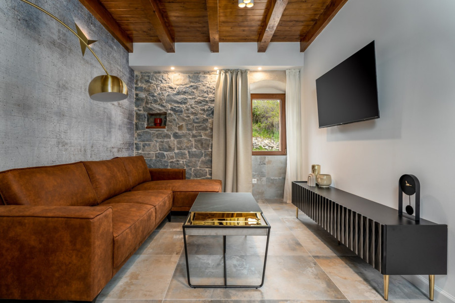 Living room with comfy sofa, flat screen TV, and WiFi, where you can spend your best vacation ever.