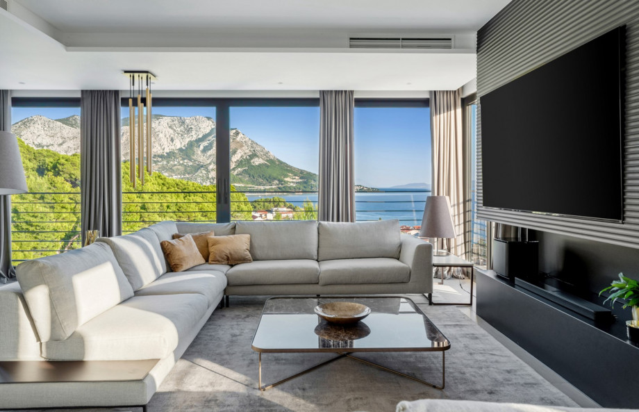 An Electric Steam Fireplace, a few sofa areas, and spectacular sea views and mountain views wherever you look