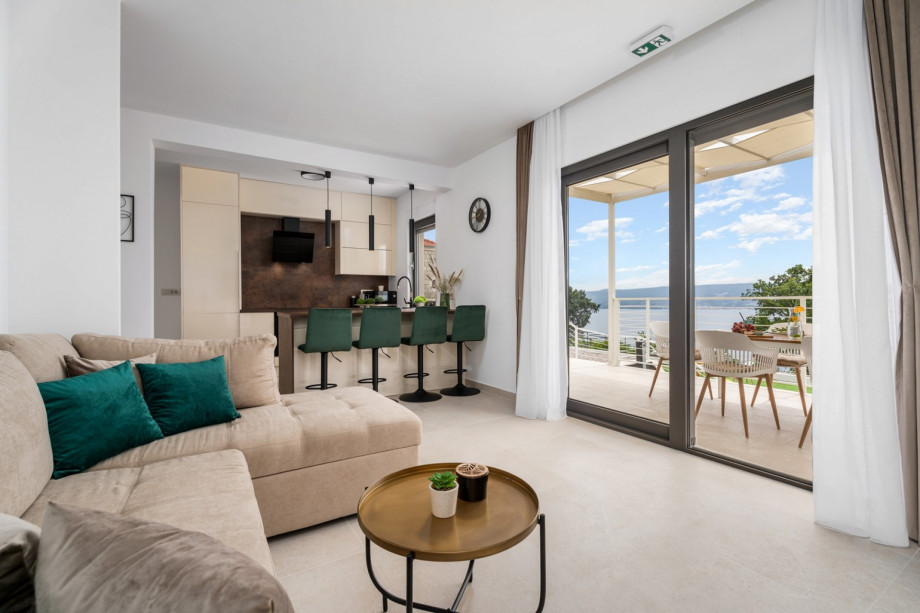 A living room area with a flat-screen TV, a sofa (can convert into a sofa bed), a free WiFi