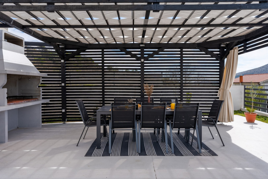 Covered lounge corner, in front of the kitchen.