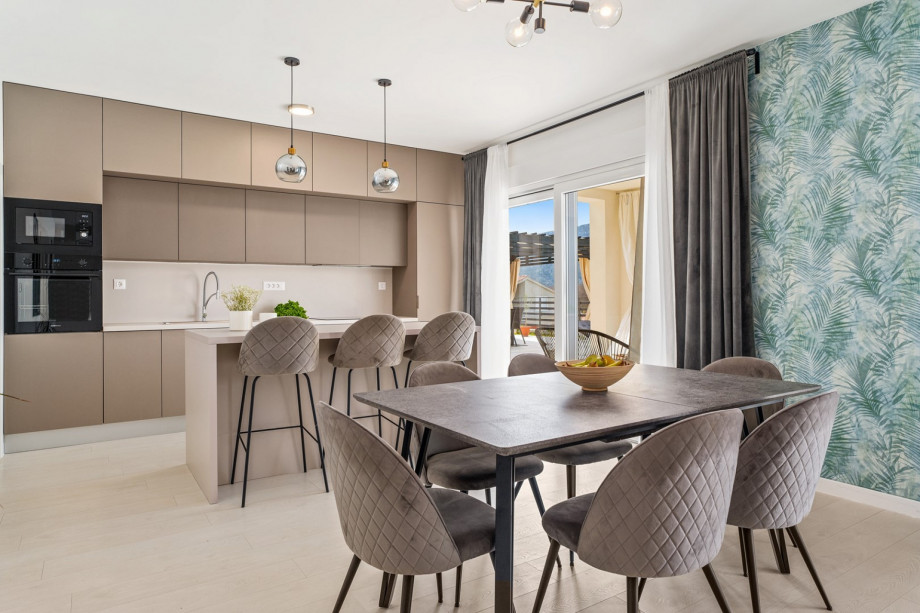 The dining area is on the ground floor with a table for 8 people.