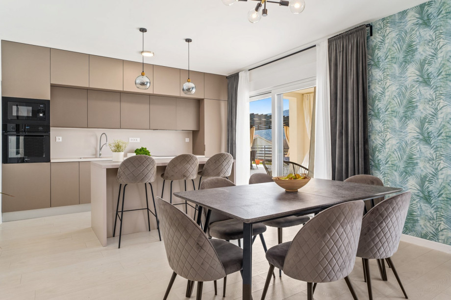 The dining area is on the ground floor with a table for 8 people.